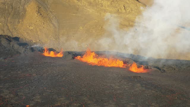 Slow motion camera view of lava bubbling in the crater. Magma coming out of the earth. Aerial view of burning lava and smokes. Extremely hot.