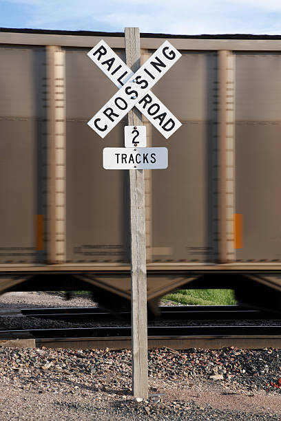 istock Railway crossing safety sign with freight train passing 184986196