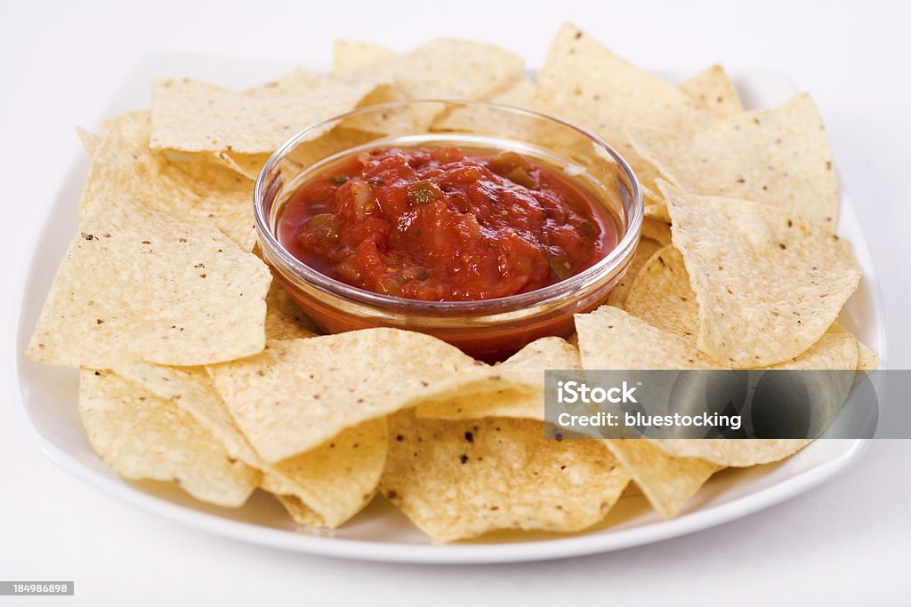 Chips and Salsa Plate of Chips and Salsa.  Focus is on the center of the salsa bowl. Salsa Sauce Stock Photo