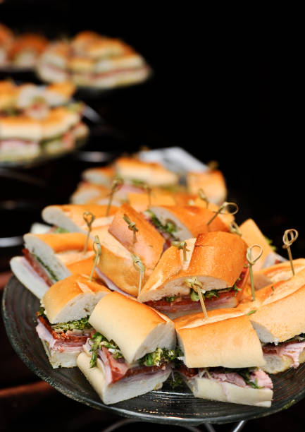 Assorted stacks of sandwiches against black background