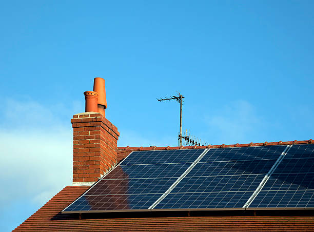 Solar energy Renewable energy - solar panels on a private house roof tile photos stock pictures, royalty-free photos & images