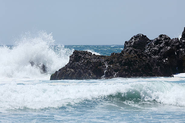 istock black spraying rocks in blue white  ocean wave 184988085