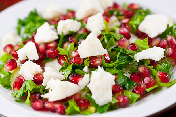 Salad with celery, pomegranate and goat cheese stock photo