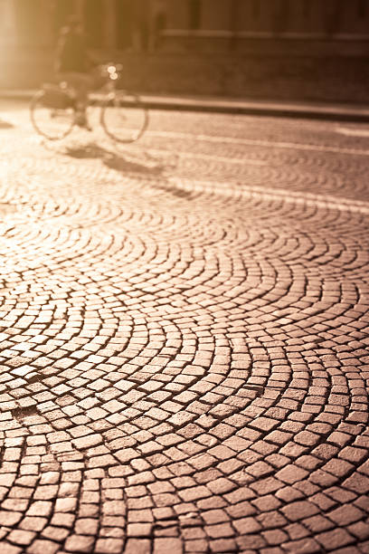 istock Bicycle Cycling at Sunset, Cobblestones Background, Tilt Shift 184989025