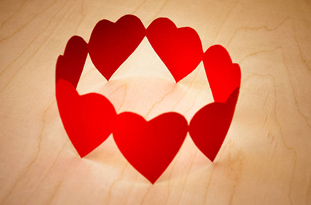 Heart shape paper dolls in circle for teamwork