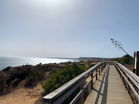 Carvoeiro boardwalk over the Algarve cliffs in Portugal. Copy cpace. Travel concept