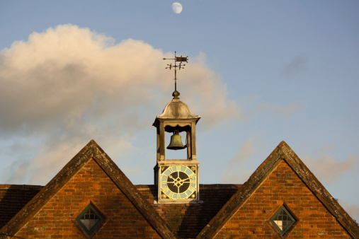 clock tower old building moon behind