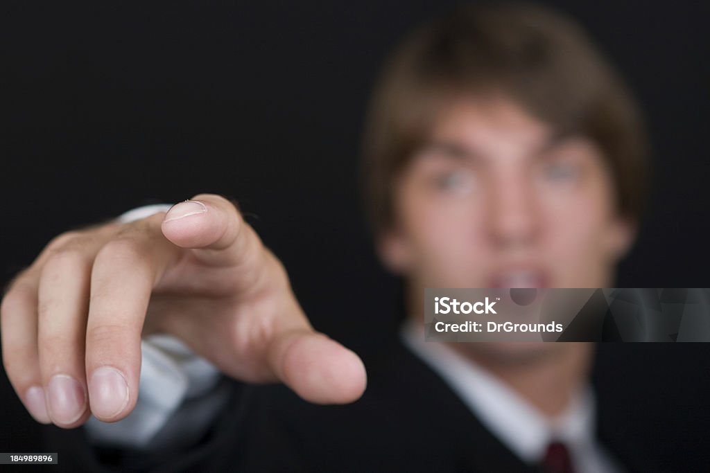 Reaching A young businessman reaching for something. Focused on indexed finger.http://www.x-grounds.com/sample.jpg Adult Stock Photo