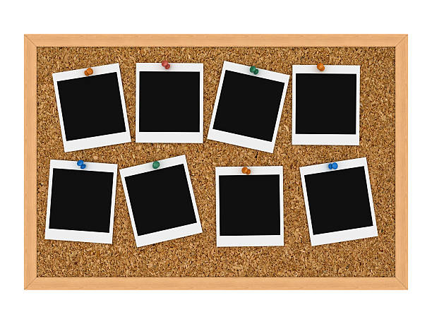 Instant pictures tacked to cork board