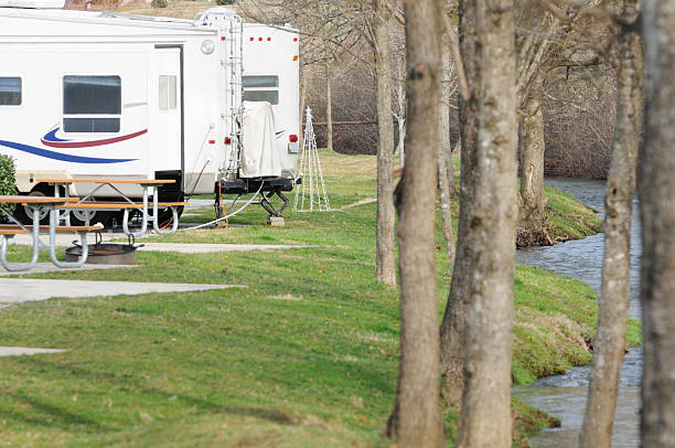 istock Recreational vehicle in campground by stream 184990015