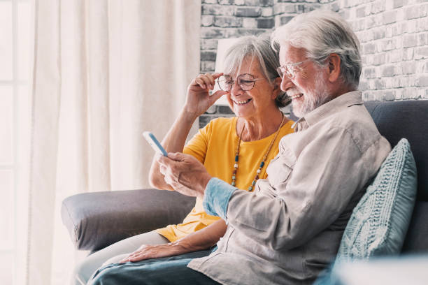 istock Elderly grandfather and grandmother spend time having fun using smartphone apps, middle-aged wife enjoy online entertainments, taking selfie with old husband, older generation and modern tech concept 1849901420