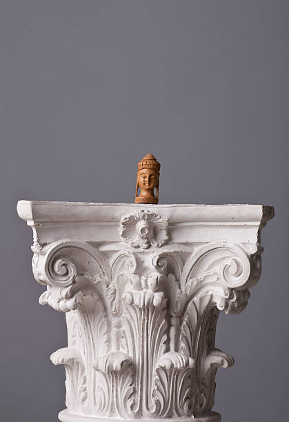 istock small buddha statue on a corinthian capital 184990215