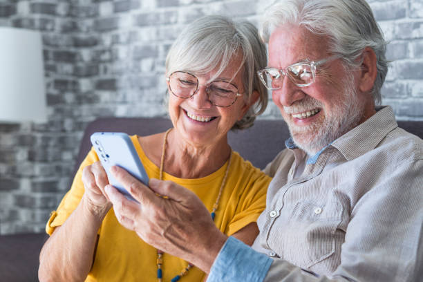 istock Elderly grandfather and grandmother spend time having fun using smartphone apps, middle-aged wife enjoy online entertainments, taking selfie with old husband, older generation and modern tech concept 1849902281