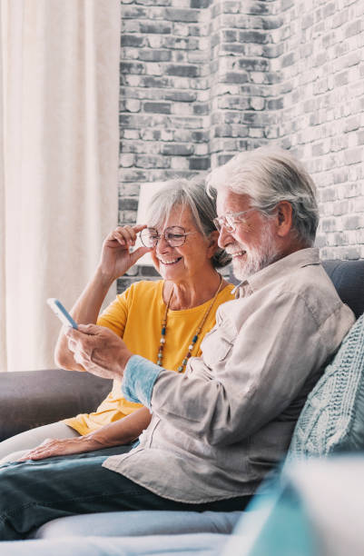 istock Elderly grandfather and grandmother spend time having fun using smartphone apps, middle-aged wife enjoy online entertainments, taking selfie with old husband, older generation and modern tech concept 1849903631