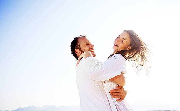 istock Happy couple enjoying on a beach 184990414