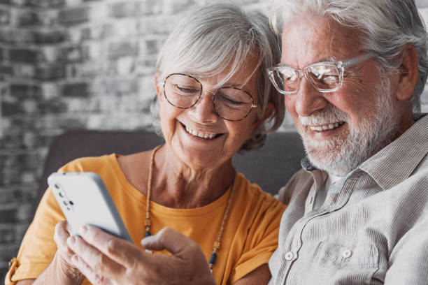 istock Elderly grandfather and grandmother spend time having fun using smartphone apps, middle-aged wife enjoy online entertainments, taking selfie with old husband, older generation and modern tech concept 1849904706
