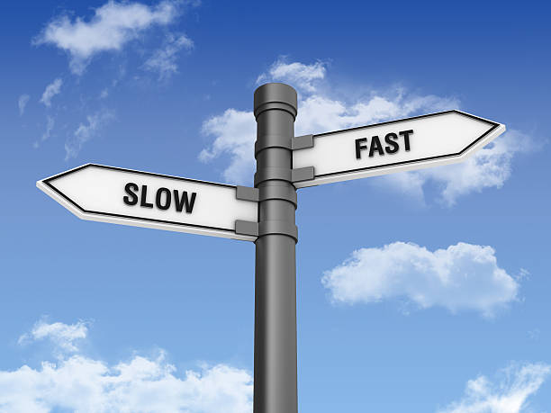 istock Directional Sign with SLOW FAST Words and Sky 184990483