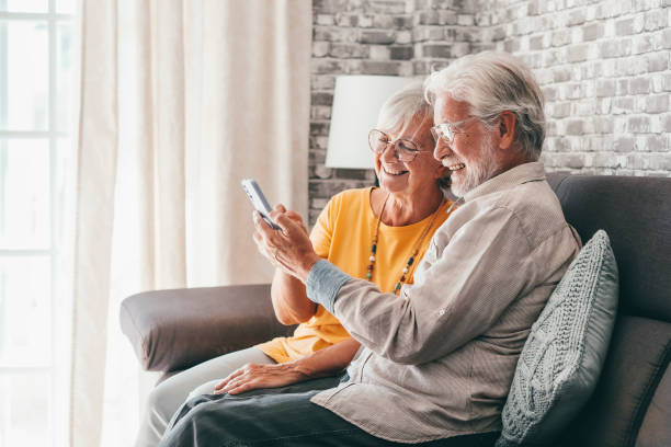 istock Elderly grandfather and grandmother spend time having fun using smartphone apps, middle-aged wife enjoy online entertainments, taking selfie with old husband, older generation and modern tech concept 1849905234