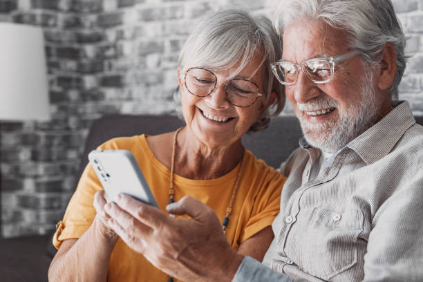 istock Elderly grandfather and grandmother spend time having fun using smartphone apps, middle-aged wife enjoy online entertainments, taking selfie with old husband, older generation and modern tech concept 1849905397