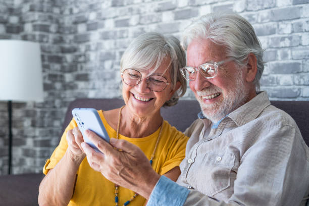 istock Elderly grandfather and grandmother spend time having fun using smartphone apps, middle-aged wife enjoy online entertainments, taking selfie with old husband, older generation and modern tech concept 1849907931