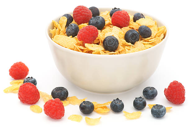 istock Bowl of corn flakes with fruits isolated on white 184990954