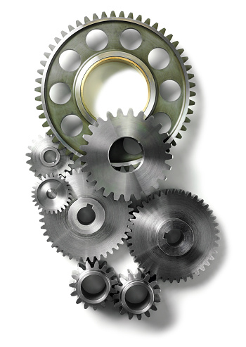 Engineering machine cogs and gears on a stainless steel background 