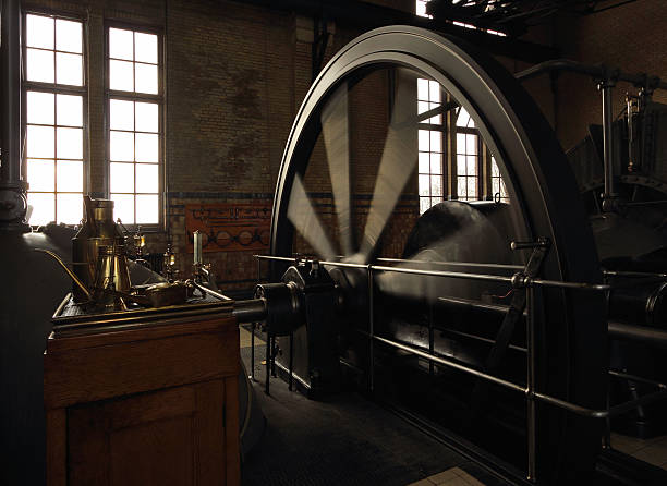 Operating steam engine with running fly wheel "Operating steam engine in the D.F. Wouda steam pumping station. This pumping station is built in 1920 and it is the largest working steam pump installation in the world.Location: Lemmer, Friesland in the Netherlands" fly wheel stock pictures, royalty-free photos & images