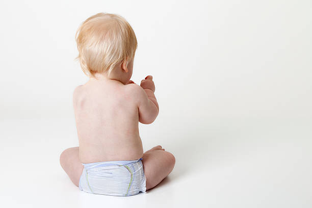istock baby in diaper with his back towards the camera 184991635