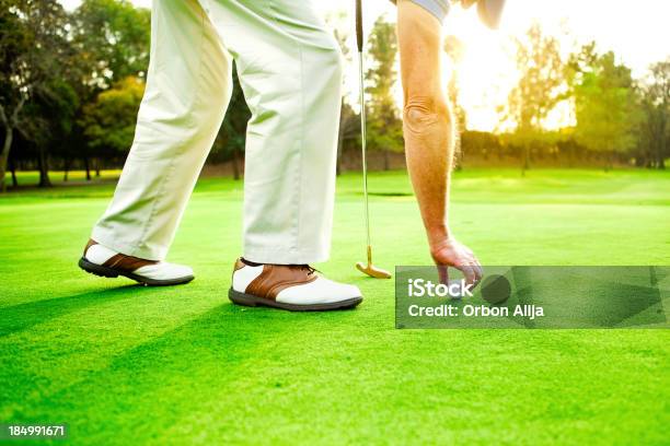 Man Placing Golf Ball Stock Photo - Download Image Now - Golf, 60-64 Years, Hobbies