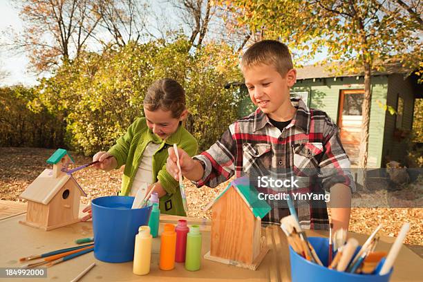 Children Working On Fun Project Of Painting Birdhouse Hz Stock Photo - Download Image Now