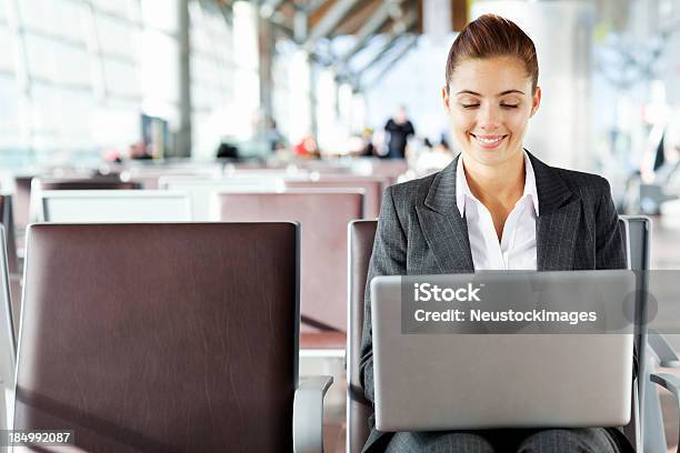 Businesswoman Working On Laptop At Airport Stock Photo - Download Image Now - Adult, Adults Only, Airport
