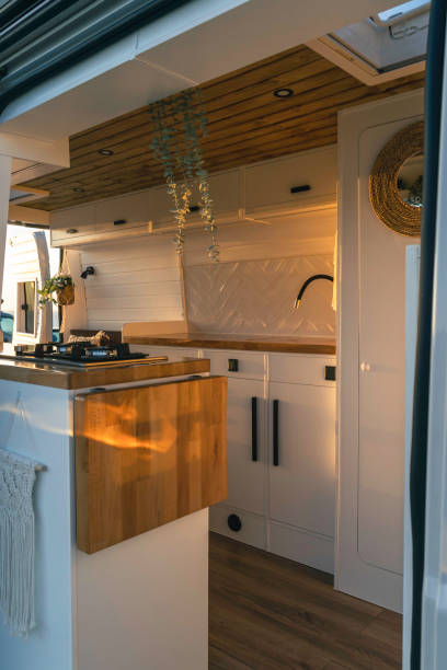 Interior of a handcrafted Nordic style camper van at sunset stock photo