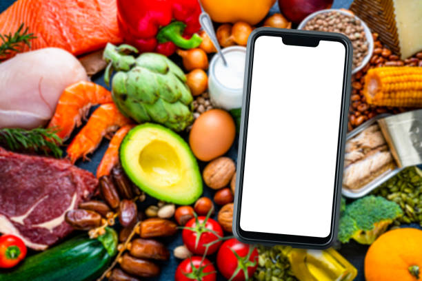 istock Mockup blank screen mobile phone on large group of food background 1849923894
