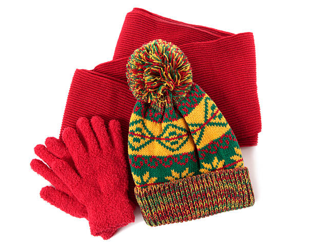 Red scarf and gloves with yellow and green knit beanie "Winter hat, scarf and gloves against a white background.  You might also like the red winter scarf shown below:" glove stock pictures, royalty-free photos & images