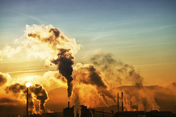 istock Morning smoke from factories with rising sun - wide 184993047