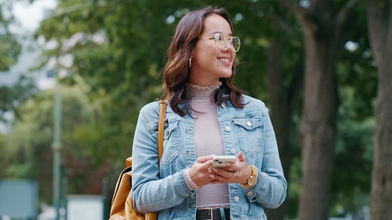 Thinking, phone or student in park on social media to chat on internet, online post or website notification. News, smile or happy woman walking on street texting, reading or typing on mobile app