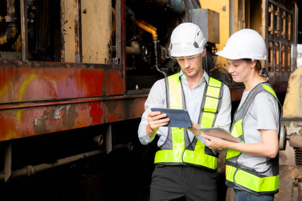 istock Young caucasian engineer man and woman checking train with tablet in station, team engineer inspect system transport, technician examining infrastructure, transportation and industry. 1849932335