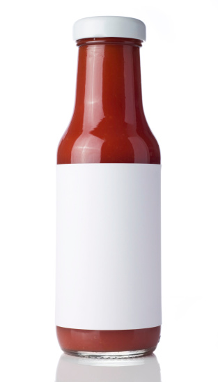 Tomato Ketchup bottle with a blank label isolated on a white background. Ideal for imposing your own artwork onto.