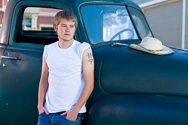istock Working man leaning against old green truck outside 184994100