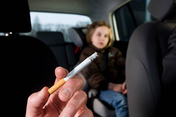 Young Children Suffering The Effects of In Car Passive Smoking stock photo