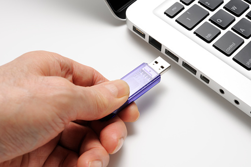 Close-up shot of connecting USB flash drive on white background.