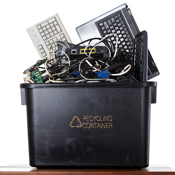 Computer Electronic Waste Old computer parts electronic waste in a bin for recycling laptop in a trash bin stock pictures, royalty-free photos & images