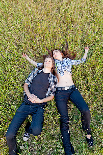 istock Cool young couple relaxing on the grass. 184995668