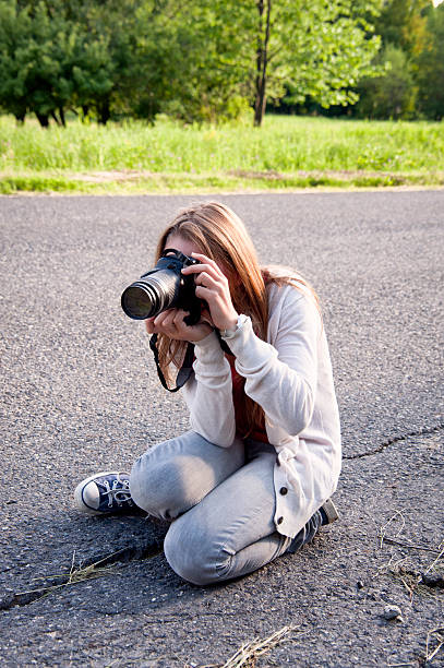 istock Young girl taking picture on a road. 184996312