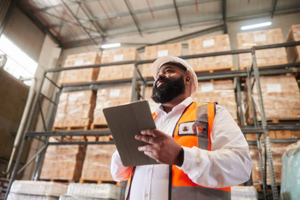 istock Male engineer working with a tablet in a large distribution warehouse 1849963689