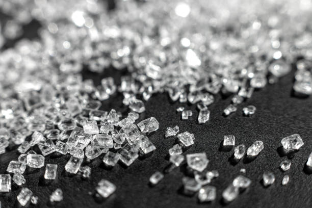 Sugar micro crystals shooted on a black - macro Sugar micro crystals shooted on a black - macro photo abstract background crystalline inclusion complex stock pictures, royalty-free photos & images