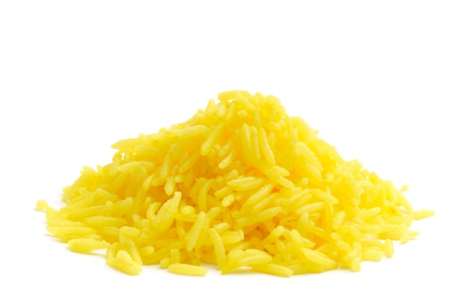 Saffron rice in a heap isolated on a white background.
