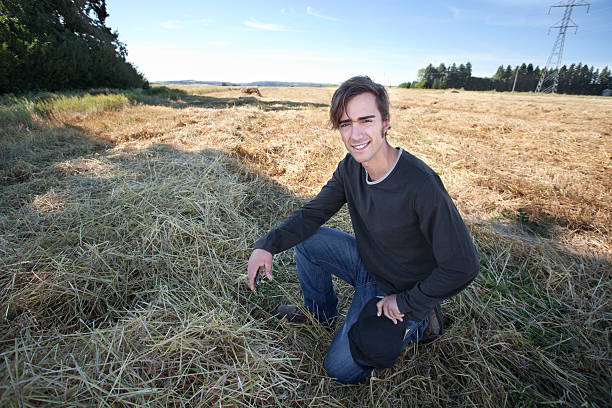 istock Young Farmer In Field Holding Phone 184996962
