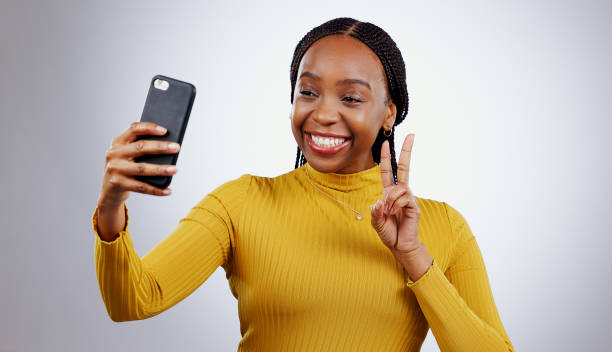 istock Studio, peace sign or black woman taking selfie on social media with confidence, post or smile. African lady, memory or happy influencer taking a photograph, vlog or picture online on grey background 1849971663