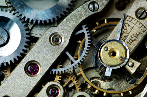 Clockworks inside an antique wristwatch showing cogs and rubies.